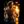 Man running at night with a blurred cityscape background