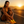 Woman in athletic wear sitting on a road at sunset with 'Levi's' logo.