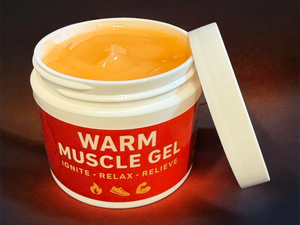 Jar of warm muscle gel with a red label on a dark background